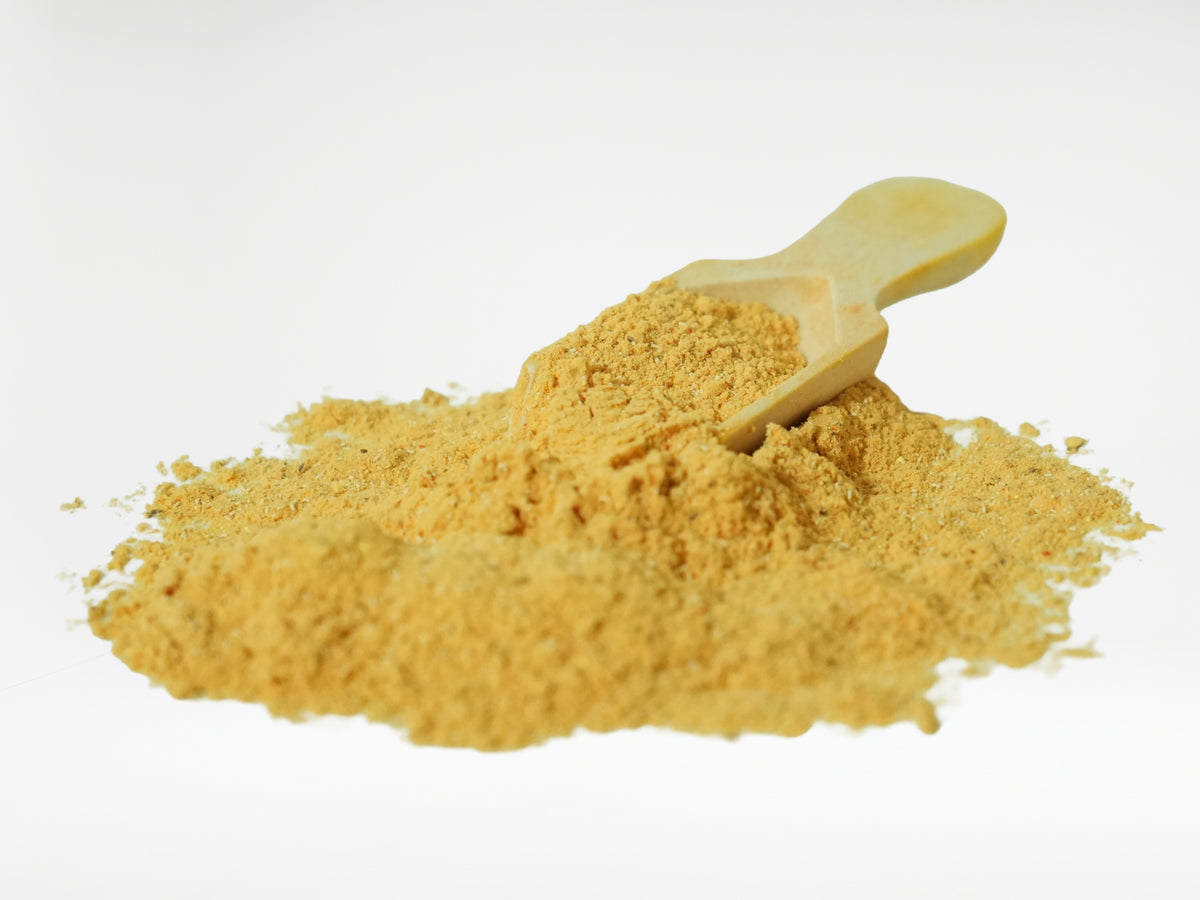 Holistic Skin & Coat Care dog supplement powder close-up with wooden scoop